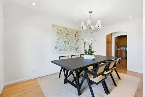 a view of a dining room with furniture and a chandelier