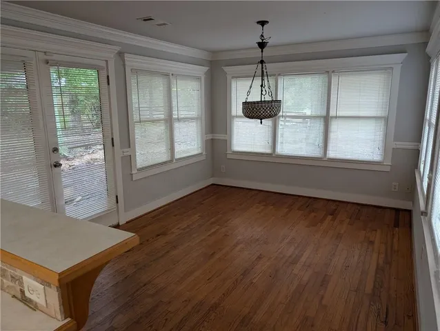 an empty room with fireplace and window