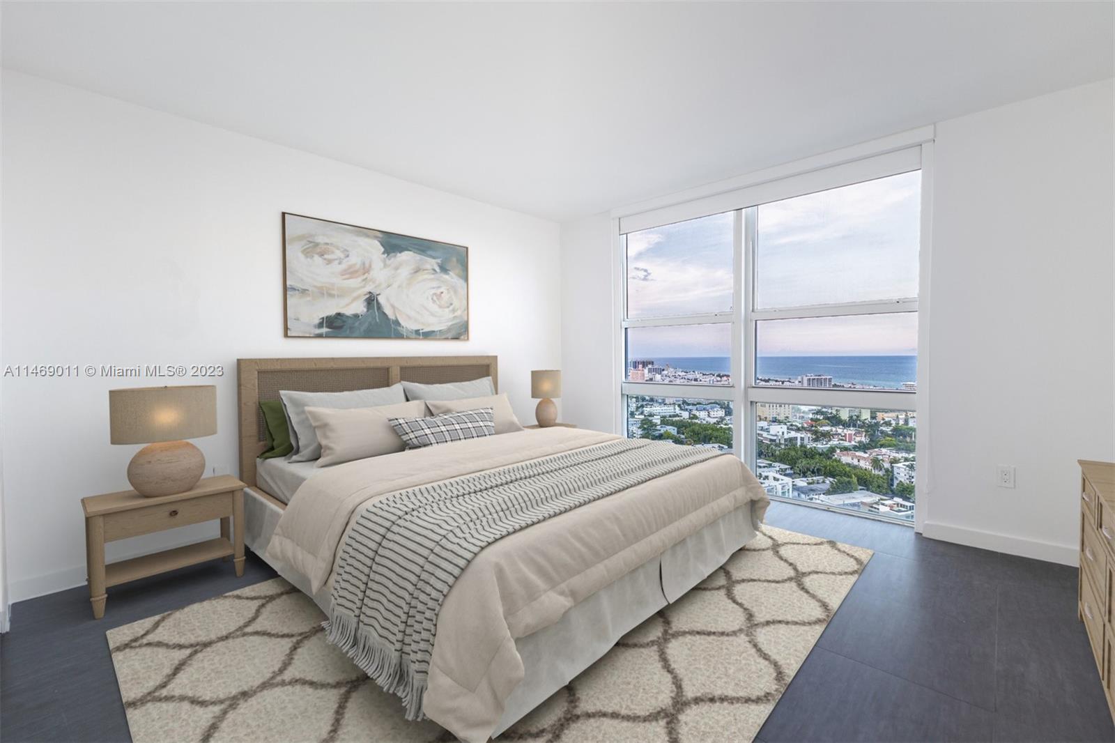 90 Alton Road, Unit 2807 Miami Beach, FL 33139 - Photo 2 of 30 a bedroom with a bed painting on wall and a large window