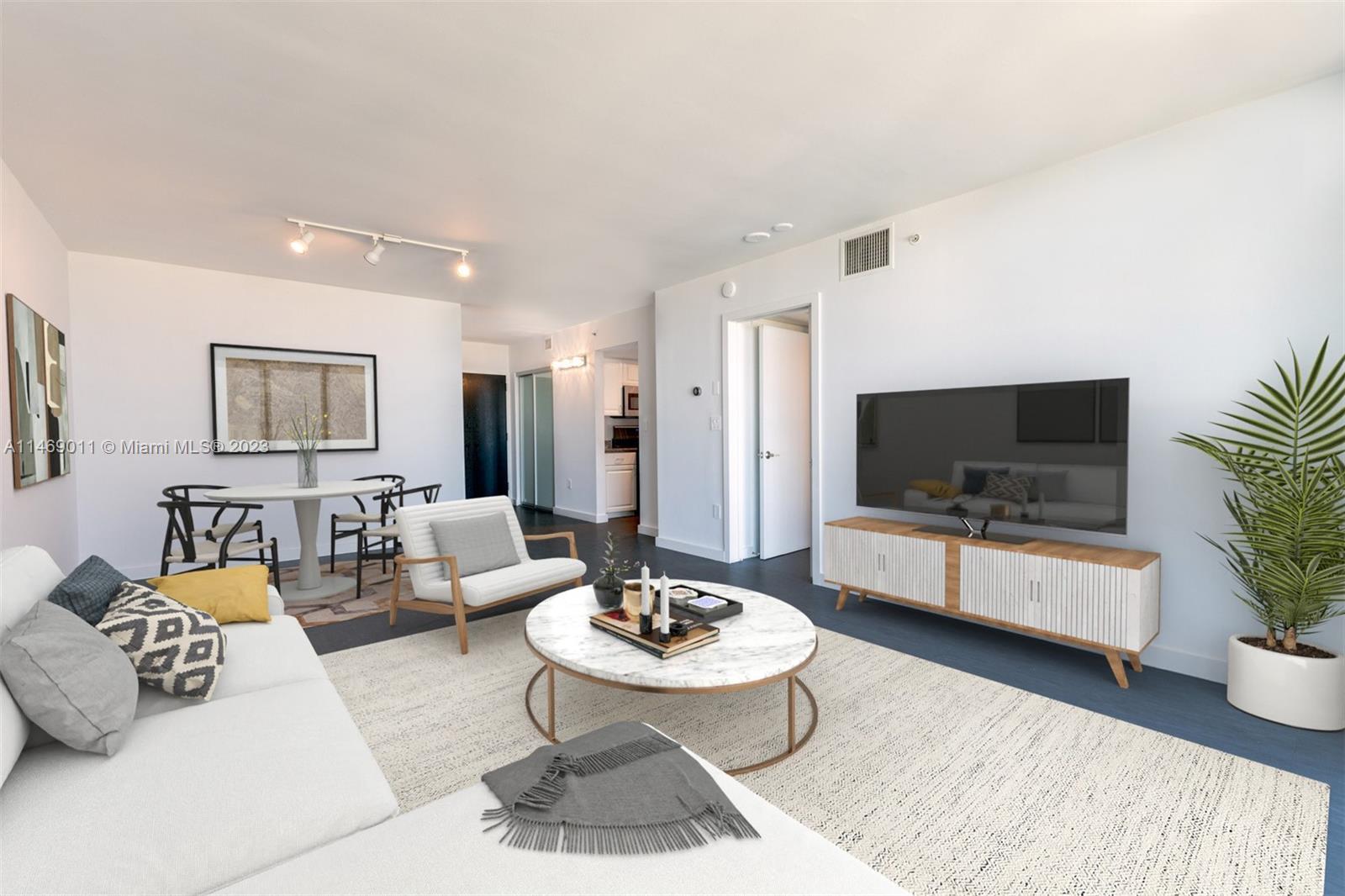 90 Alton Road, Unit 2807 Miami Beach, FL 33139 - Photo 3 of 30 a living room with furniture and a flat screen tv