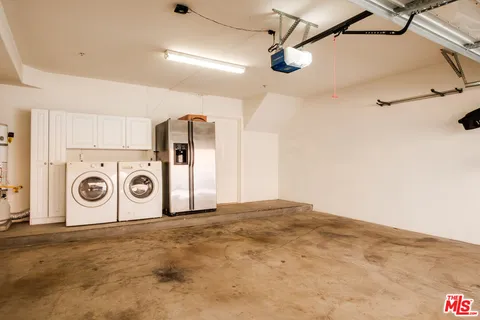 a view of a storage & utility room with a washer dryer