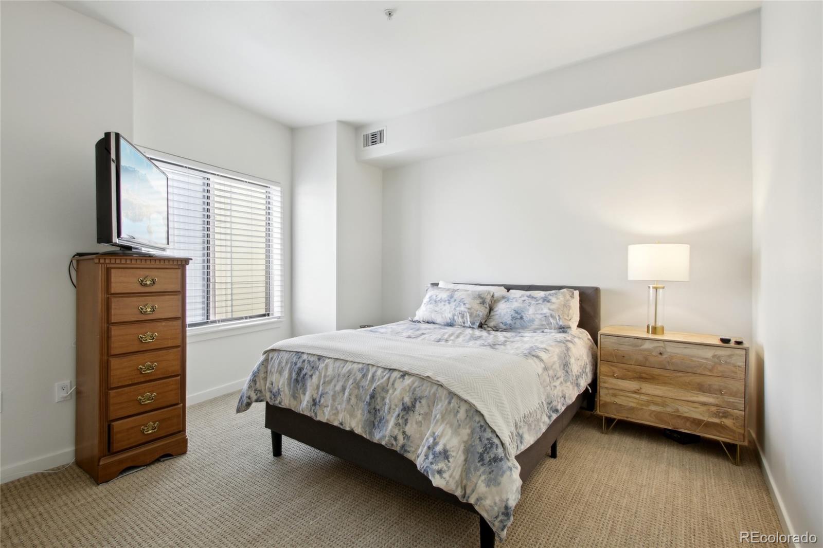 4520 Broadway, Unit 208 Boulder, CO 80304 - Photo 18 of 39 a bedroom with a bed and a television