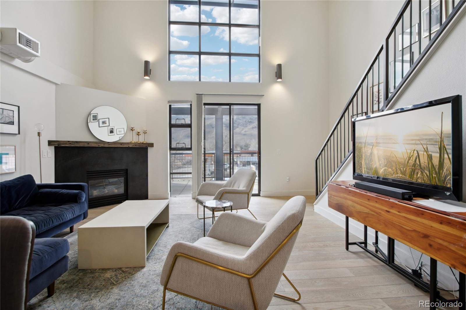 4520 Broadway, Unit 208 Boulder, CO 80304 - Photo 5 of 39 a living room with furniture a flat screen tv and a fireplace