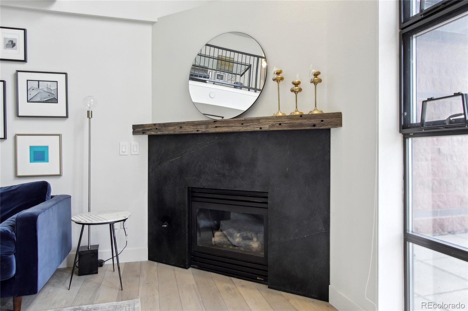 4520 Broadway, Unit 208 Boulder, CO 80304 - Photo 7 of 39 a living room with furniture a mirror and a fireplace