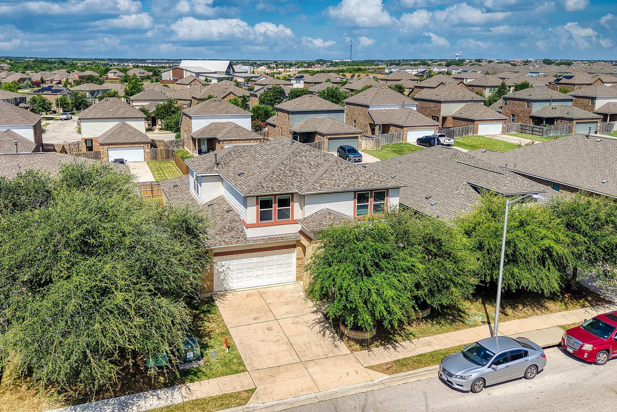 1341 Eagle Ray Street Leander, TX 78641 - Photo 27 of 37 An inviting suburban dwelling with a private driveway and attached garage.