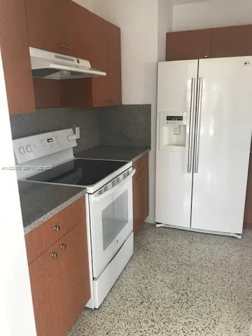 a stove top oven sitting inside of a kitchen