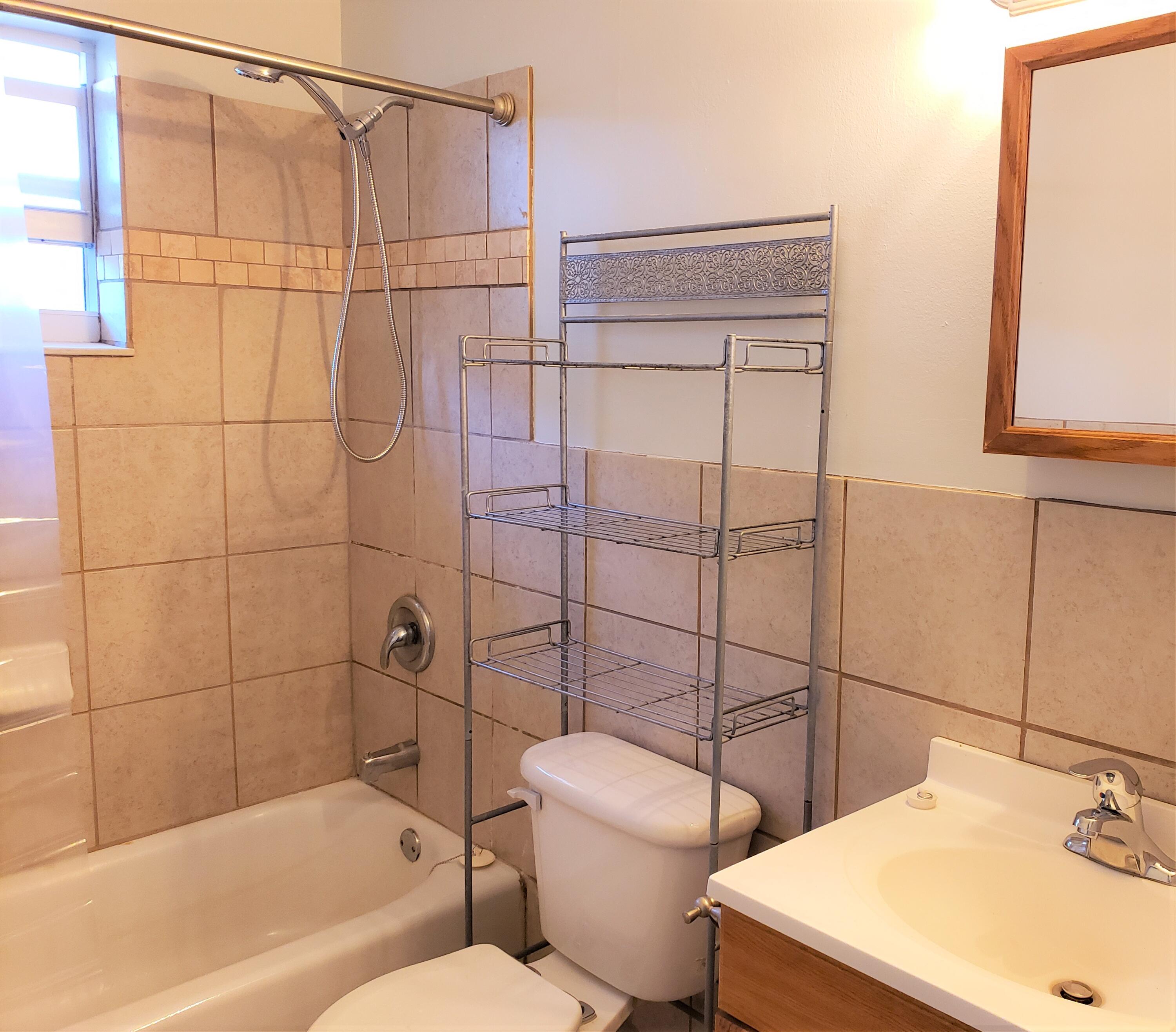 4752 Southeast Ebbtide Avenue, Unit 4752 Stuart, FL 34997 - Photo 5 of 8 a bathroom with a sink toilet and shower