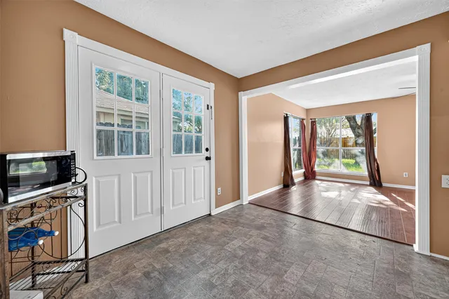 a view of an empty room with a fireplace and a window
