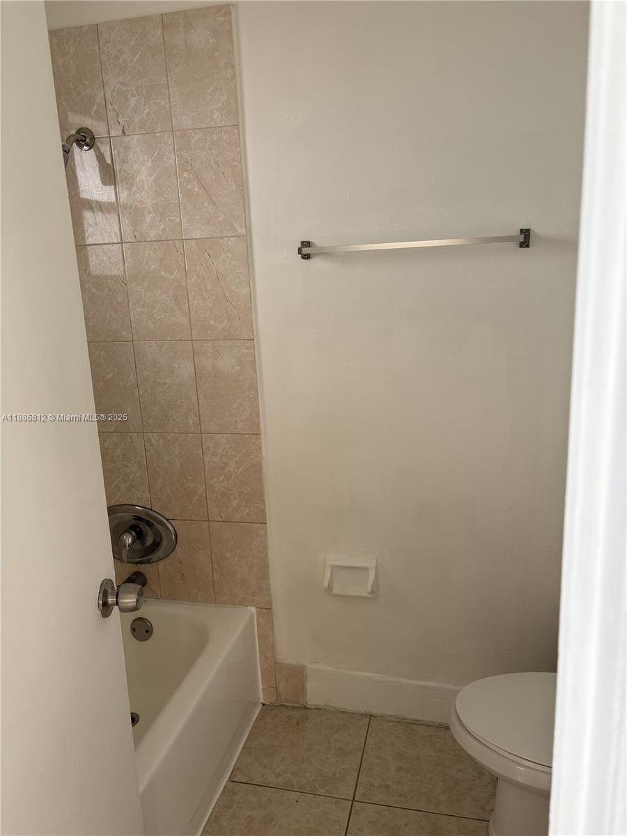 3675 West 11th Avenue, Unit 319 Hialeah, FL 33012 - Photo 12 of 15 a bathroom with a tub and toilet