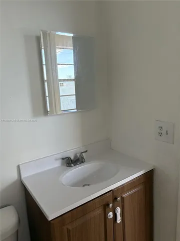 a bathroom with a sink a vanity and a mirror