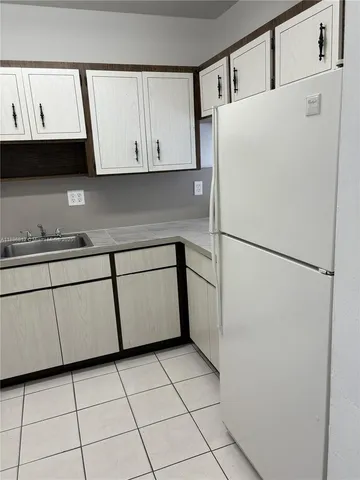 a white refrigerator freezer sitting inside of a kitchen