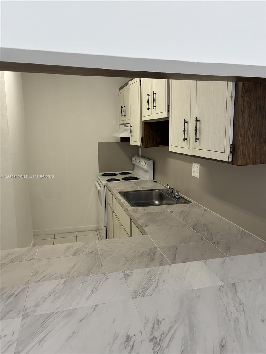 3675 West 11th Avenue, Unit 319 Hialeah, FL 33012 - Photo 9 of 15 a room with a sink and a window