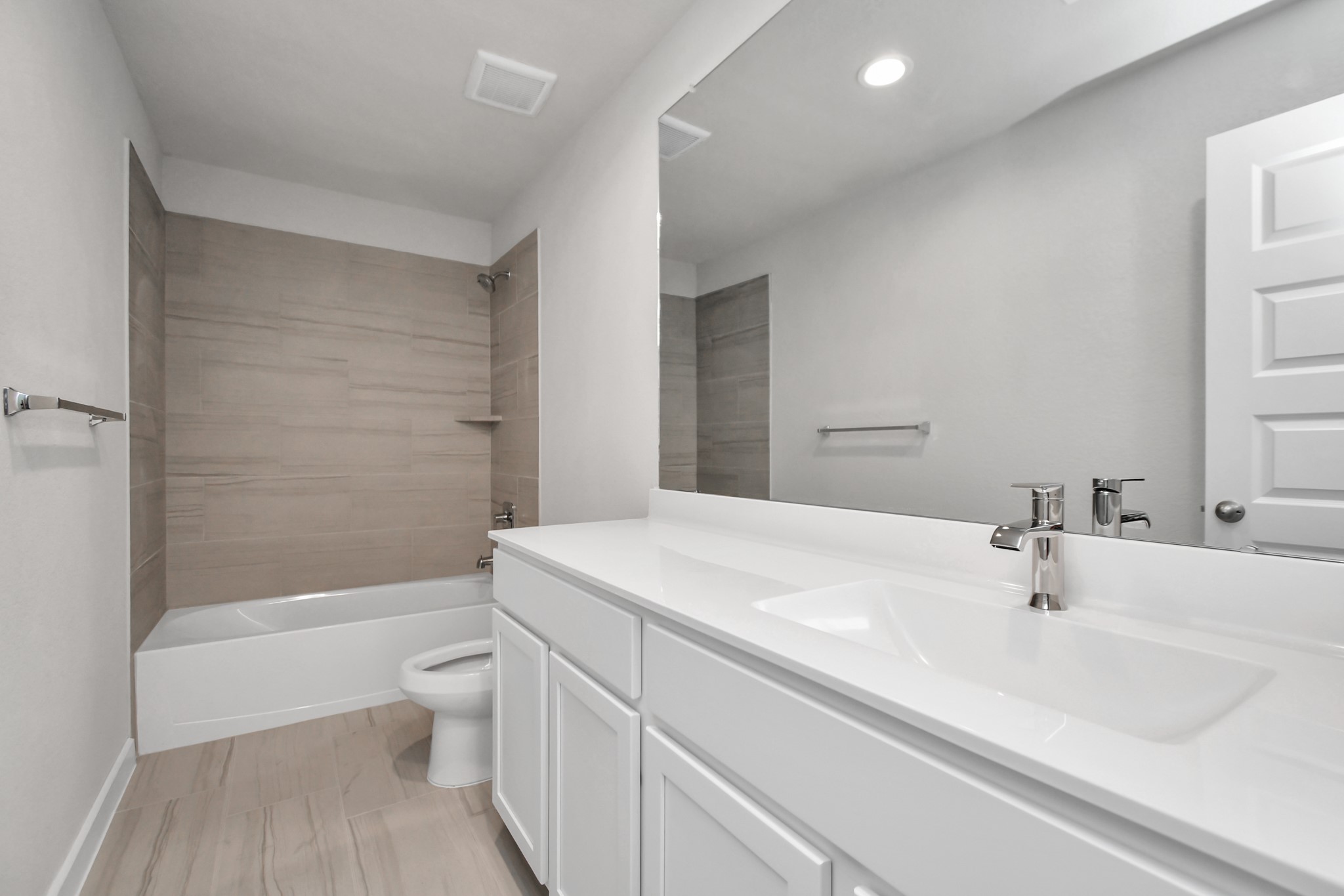 15111 Statice Trail Houston, TX 77044 - Photo 31 of 35 Bath/shower combo surrounded by tasteful tile in this secondary bath. Sample photo of completed home with similar floor plan. Actual colors and selections may vary.