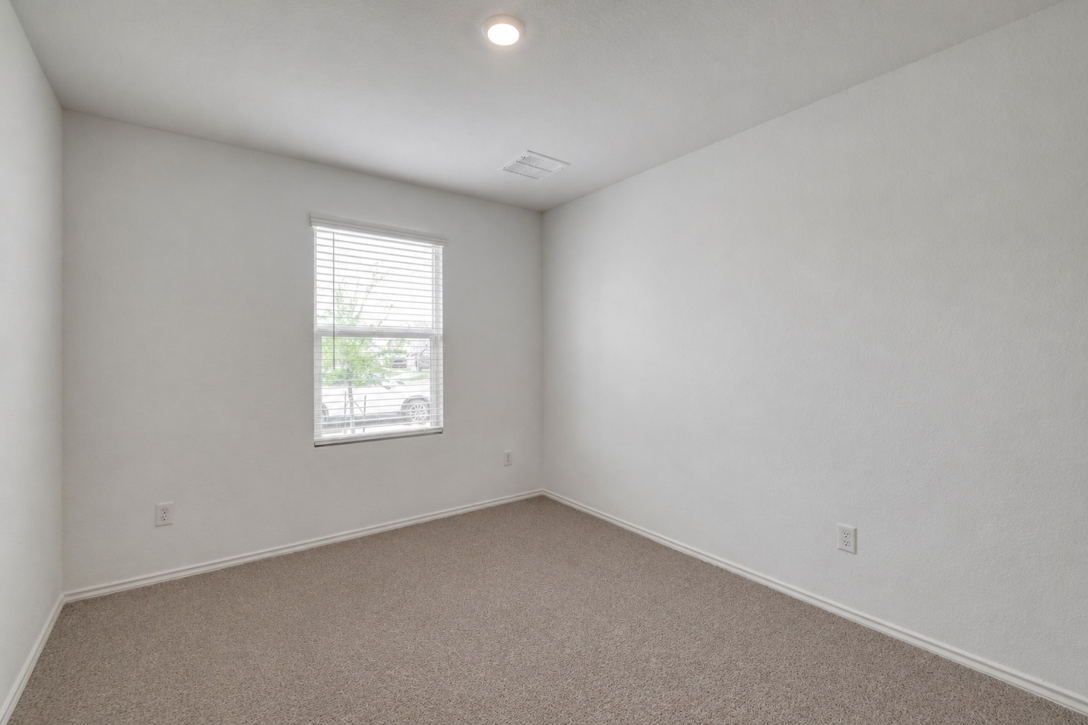 23412 Tiny Moons Way Elgin, TX 78621 - Photo 29 of 38 Bright room featuring neutral-toned carpet, white walls, and a single window with horizontal blinds