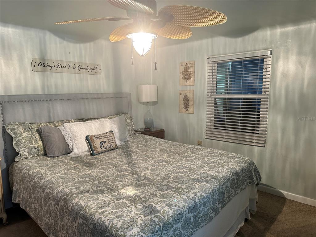 357 Magnolia Place DeBary, FL 32713 - Photo 29 of 50 a large bed sitting in a bedroom next to a window and a chandelier