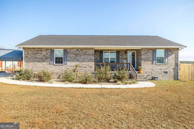 a front view of house with yard and seating space