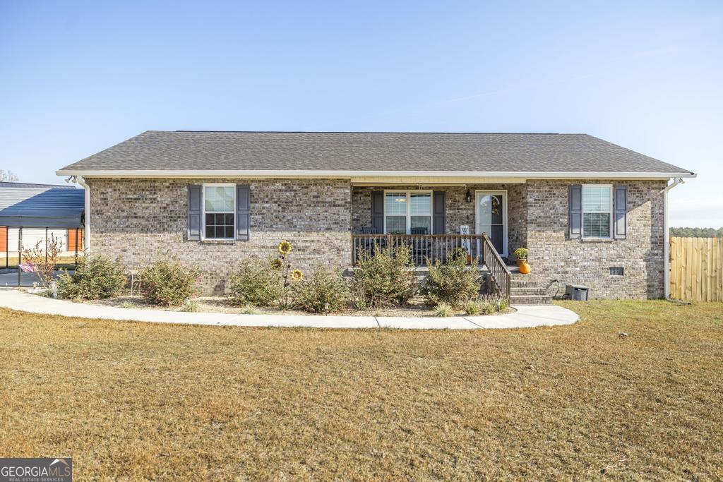 a front view of house with yard and seating space