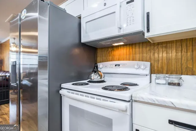 a view of a dining room with furniture and a window