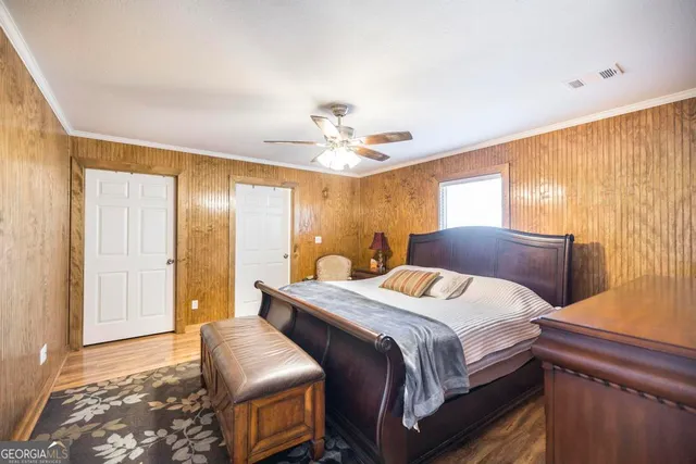 a bedroom with a large bed and a chandelier
