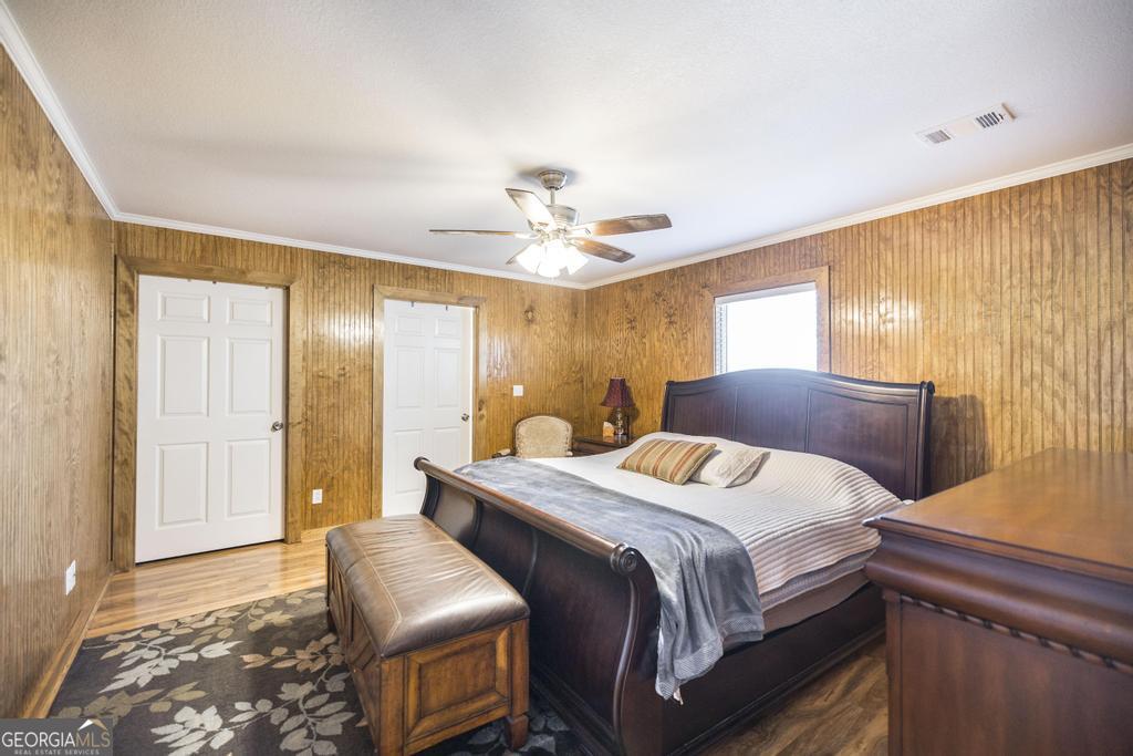 177 Lovett Scott Road Adrian, GA 31002 - Photo 16 of 37 a bedroom with a bed and a chandelier