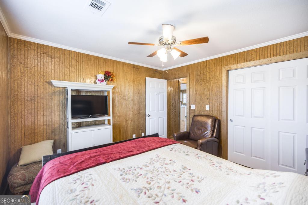 177 Lovett Scott Road Adrian, GA 31002 - Photo 19 of 37 a bedroom with a bed and a flat screen tv