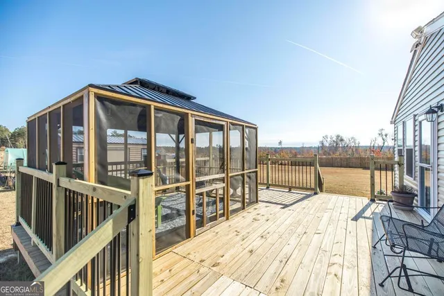 a view of a house with swimming pool and sitting area