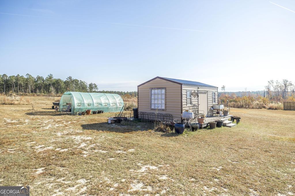 177 Lovett Scott Road Adrian, GA 31002 - Photo 27 of 37 a view of a house with a yard and sitting area