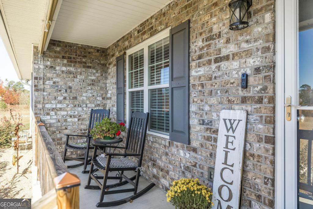 177 Lovett Scott Road Adrian, GA 31002 - Photo 5 of 37 a outdoor living space with patio furniture and potted plants