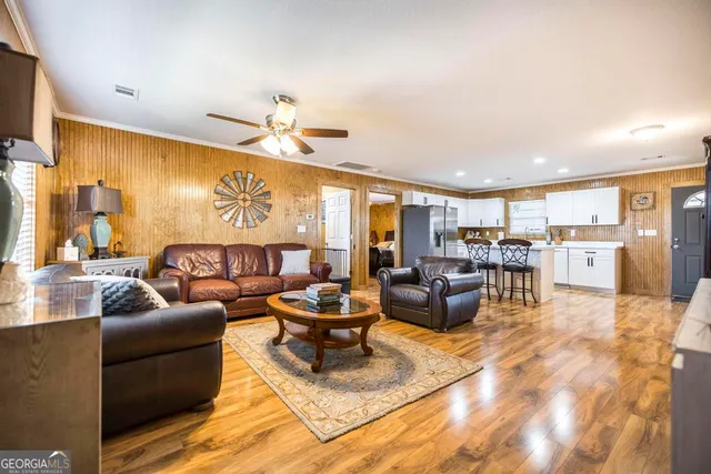 a living room with furniture and a flat screen tv