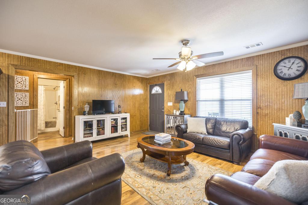 177 Lovett Scott Road Adrian, GA 31002 - Photo 8 of 37 a living room with furniture a fireplace and a large window