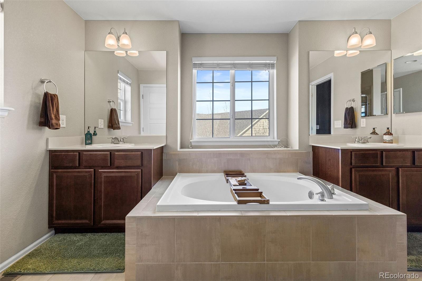 10039 Buttesfield Street Firestone, CO 80504 - Photo 15 of 35 a bathroom with a tub sink and mirror