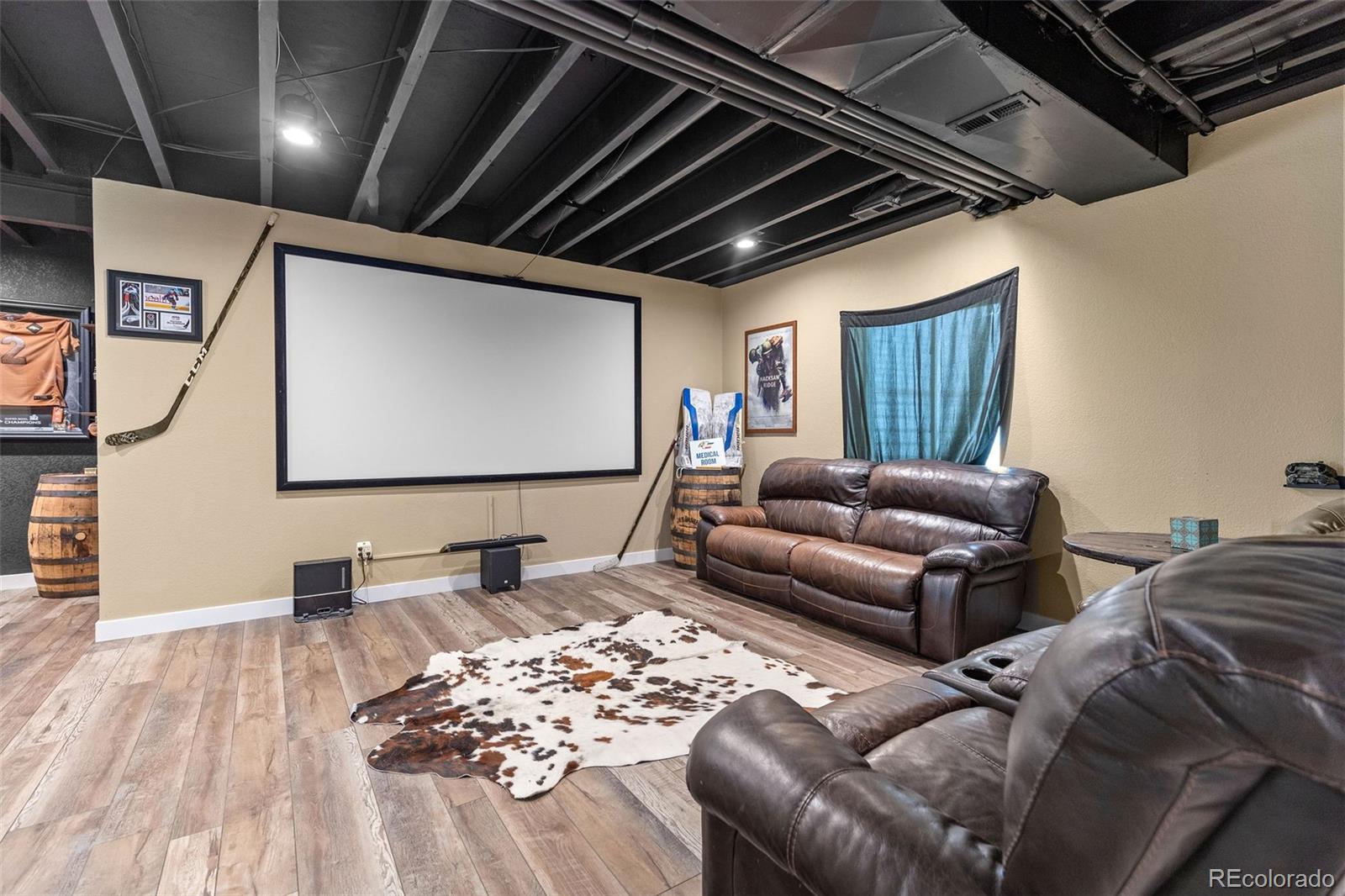 10039 Buttesfield Street Firestone, CO 80504 - Photo 22 of 35 a living room with a couch and a flat screen tv