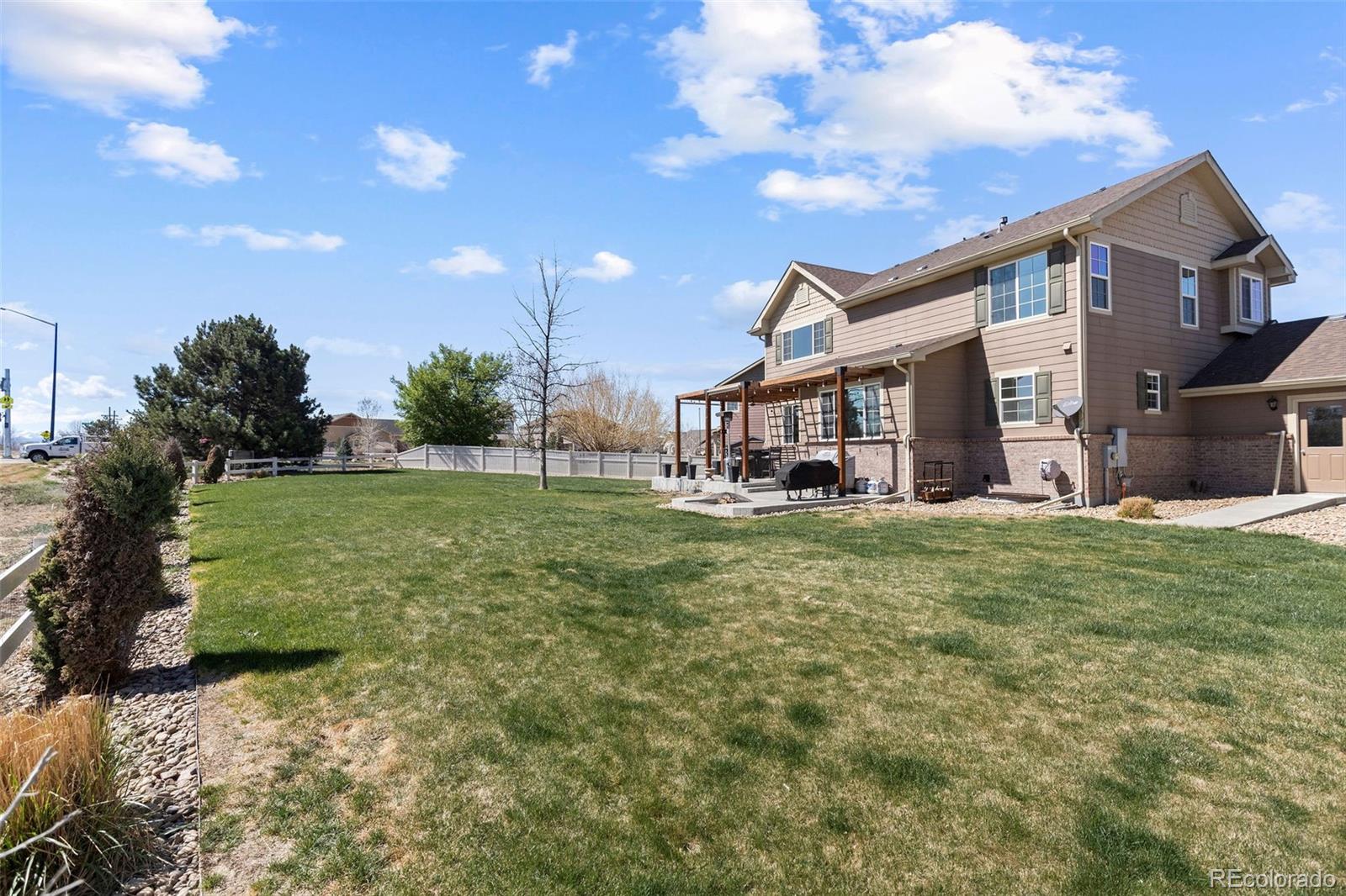 10039 Buttesfield Street Firestone, CO 80504 - Photo 28 of 35 a view of a house with a backyard porch and sitting area