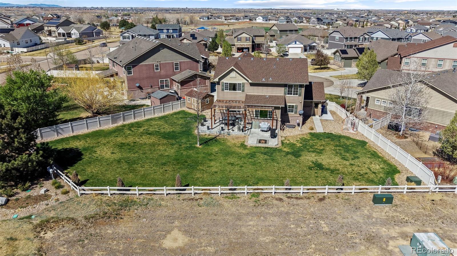 10039 Buttesfield Street Firestone, CO 80504 - Photo 31 of 35 an aerial view of a house with a yard and garage
