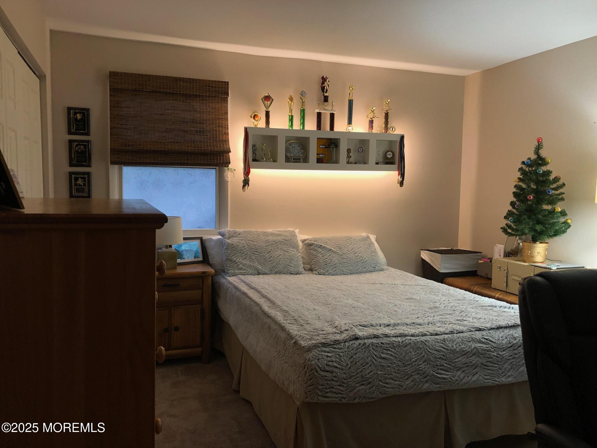 219 Lexington Drive Little Egg Harbor, NJ 08087 - Photo 15 of 30 a bedroom with a bed and a flat screen tv