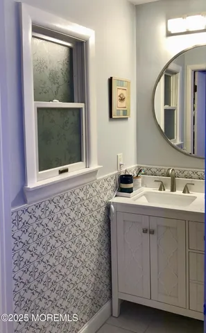a bathroom with a sink a vanity and a mirror