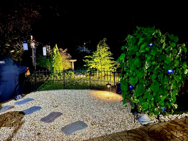 a view of a back yard of the house and a fountain