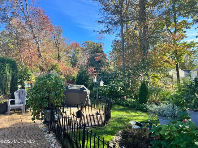 a view of a wooden dinning table and chairs in the patio