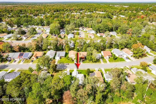 an aerial view of residential houses with outdoor space and swimming pool