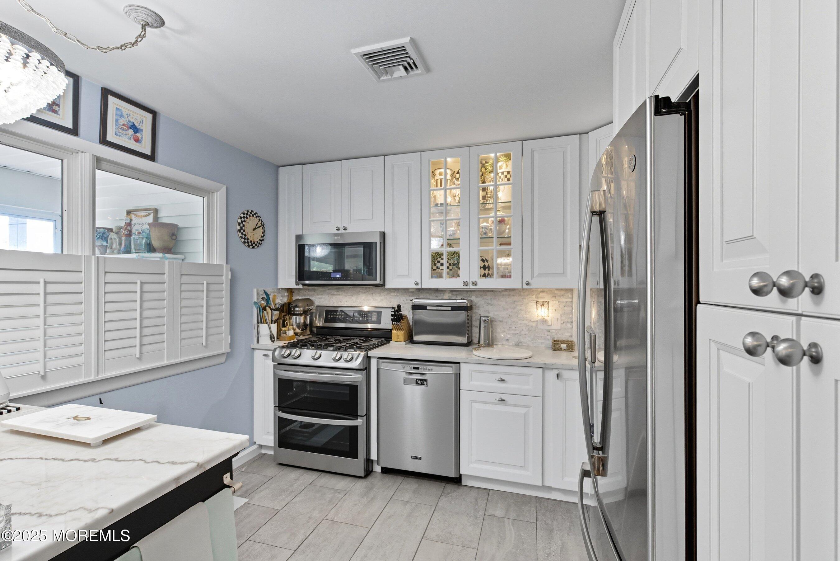 219 Lexington Drive Little Egg Harbor, NJ 08087 - Photo 6 of 30 a kitchen with stainless steel appliances a stove sink and refrigerator