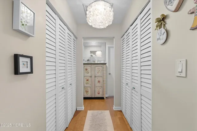 a view of a hallway with chandelier