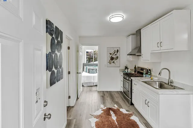 a kitchen with white cabinets and appliances