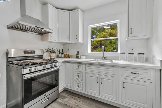 a kitchen with a table chairs stove and cabinets