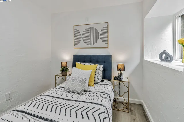 a bedroom with a bed and painting on the wall