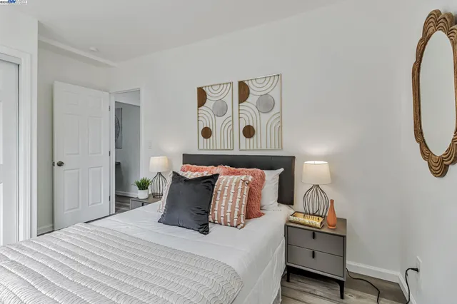 a bedroom with a bed and wooden floor