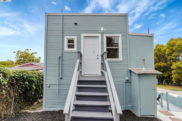 a view of a chairs and table in backyard of the house