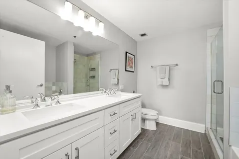 a white bath tub sitting next to a toilet