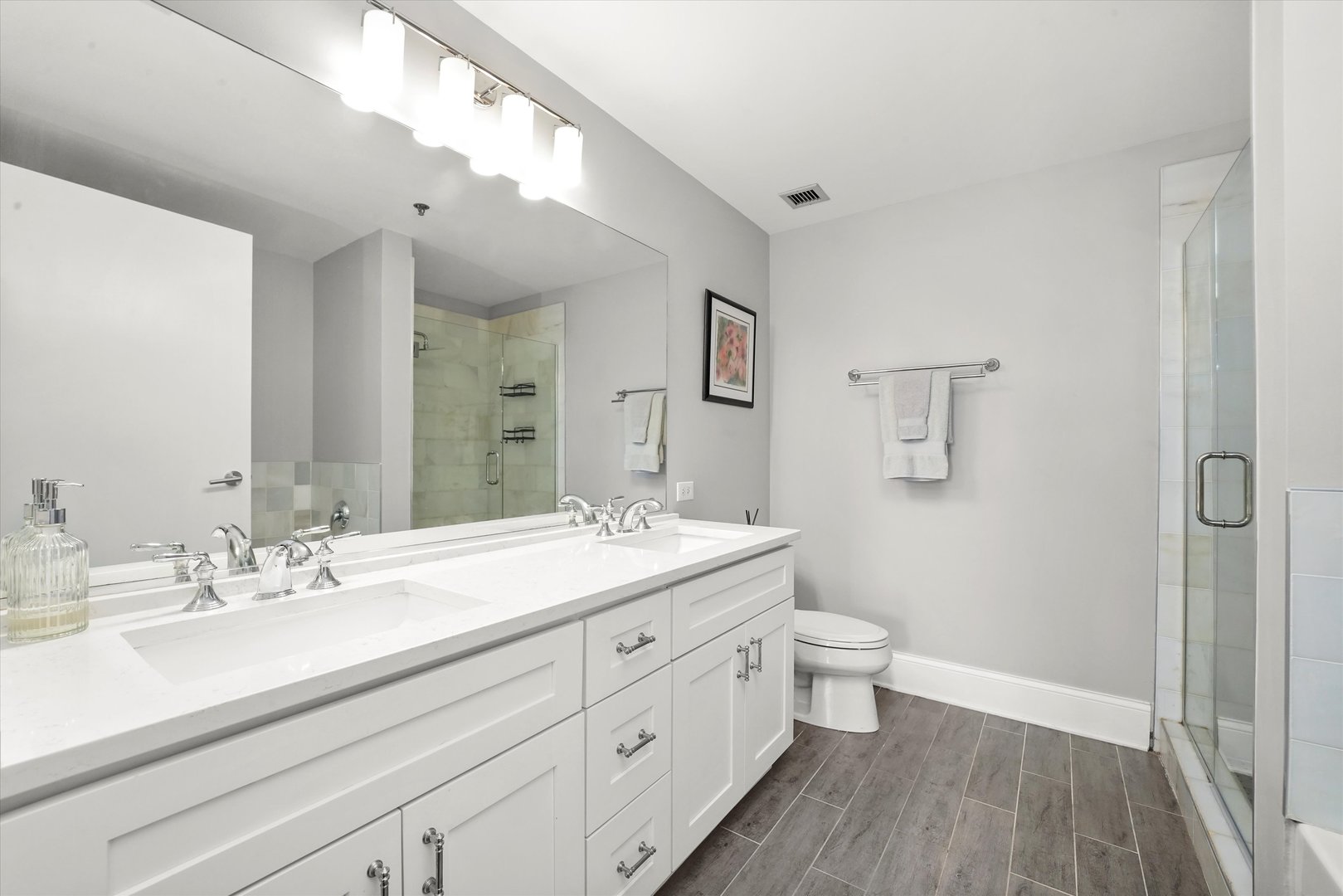 1515 South Prairie Avenue, Unit 910 Chicago, IL 60605 - Photo 16 of 32 a bathroom with a double vanity sink toilet and a mirror