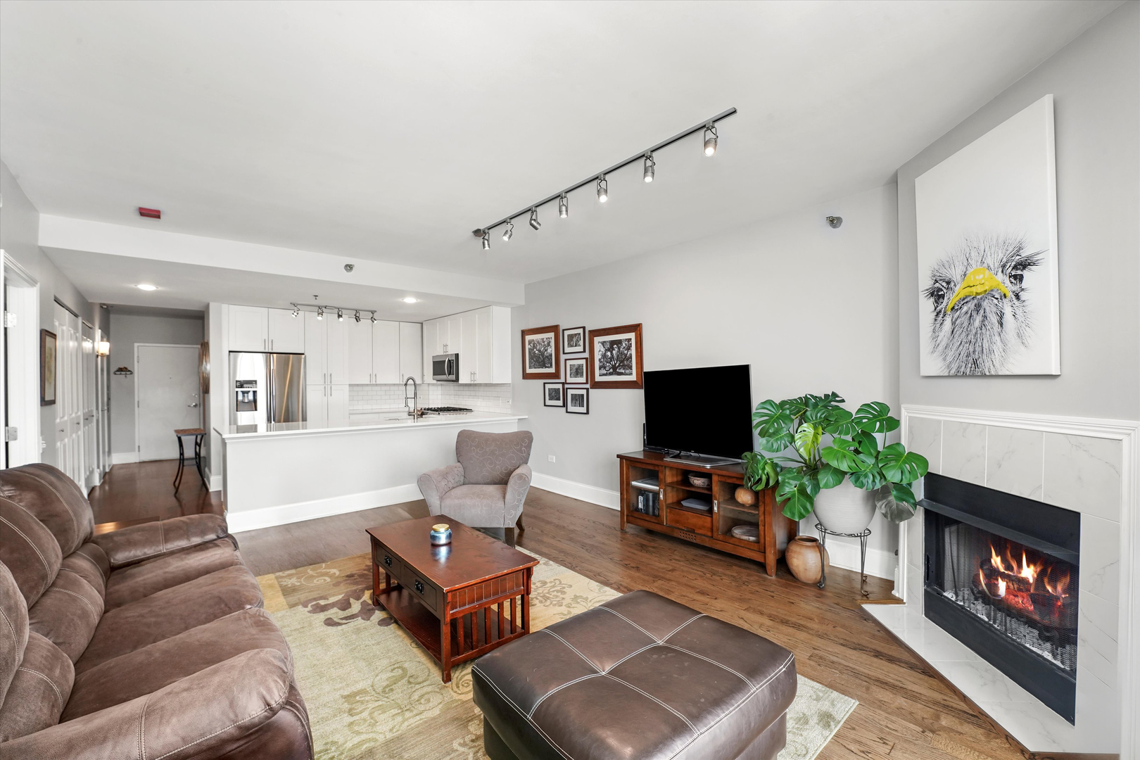 1515 South Prairie Avenue, Unit 910 Chicago, IL 60605 - Photo 9 of 32 a living room with furniture a fireplace and a flat screen tv