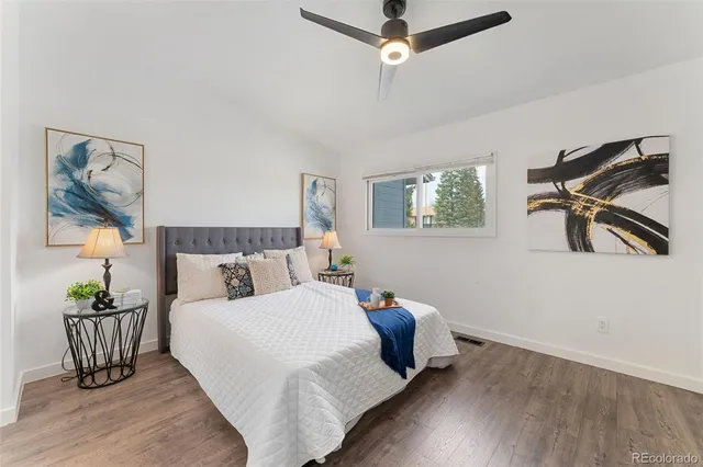 a bed room with a bed and a painting